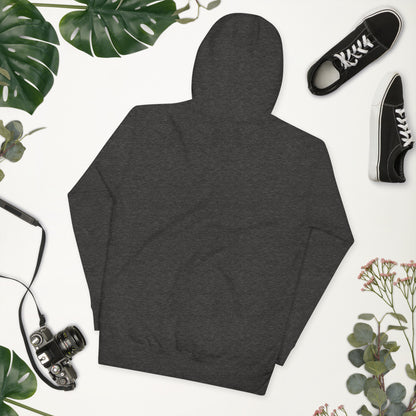 Dark gray hoodie on a white background with plants and shoes around