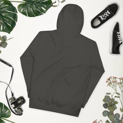 Dark gray hoodie on a white background with plants and black sneakers.