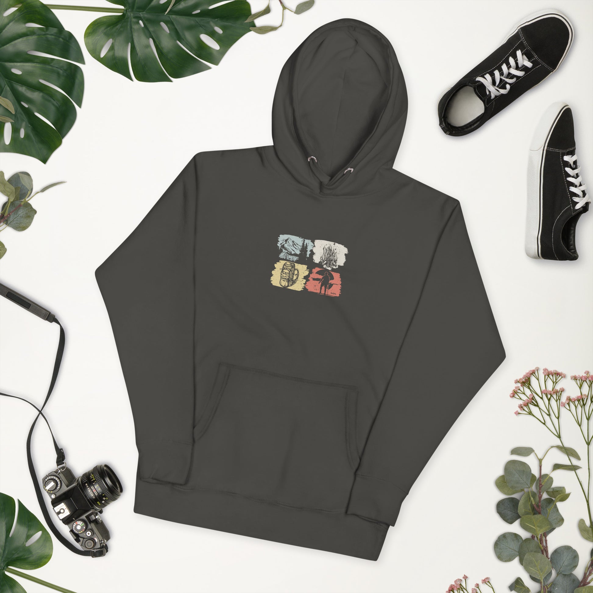 Dark gray hoodie with a colorful graphic on a white background with greenery