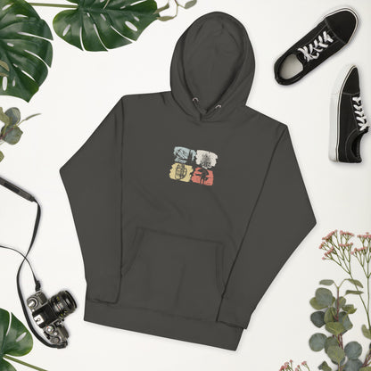 Dark gray hoodie with a colorful graphic on a white background with greenery