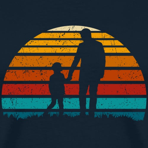 Silhouette of a man and child holding hands against a colorful sunset background on a dark blue shirt.