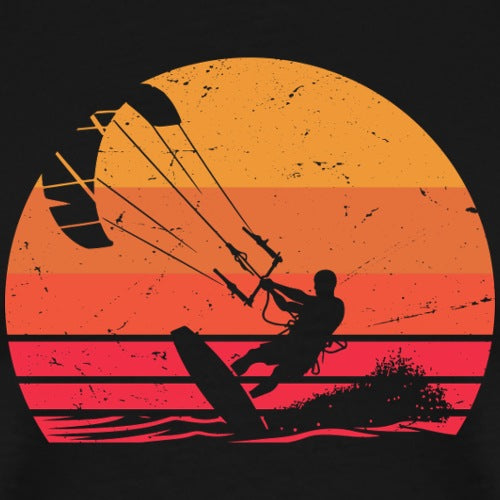 Silhouette of a person kiteboarding against a sunset background