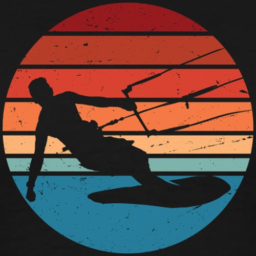 Silhouette of a person kiteboarding against a sunset sky with a circular design.