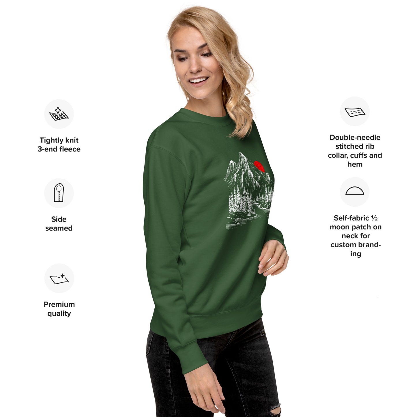 Woman wearing a green sweatshirt with a mountain sketch forest graphic, surrounded by text about sweatshirt features.