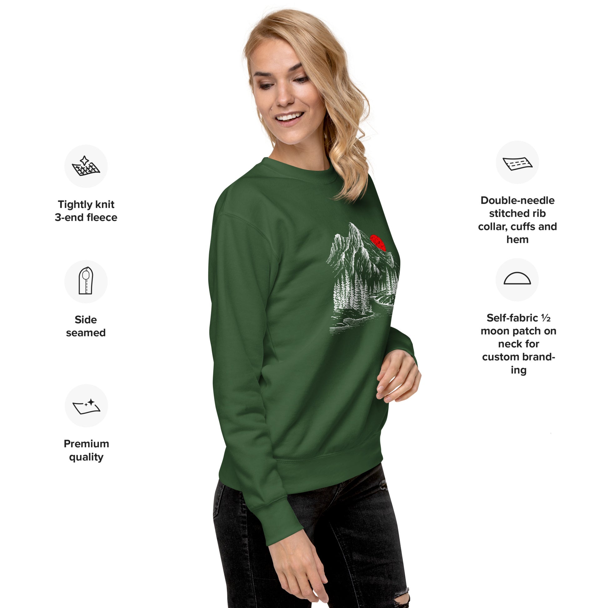 Woman wearing a green sweatshirt with a mountain sketch forest graphic, surrounded by text about sweatshirt features.
