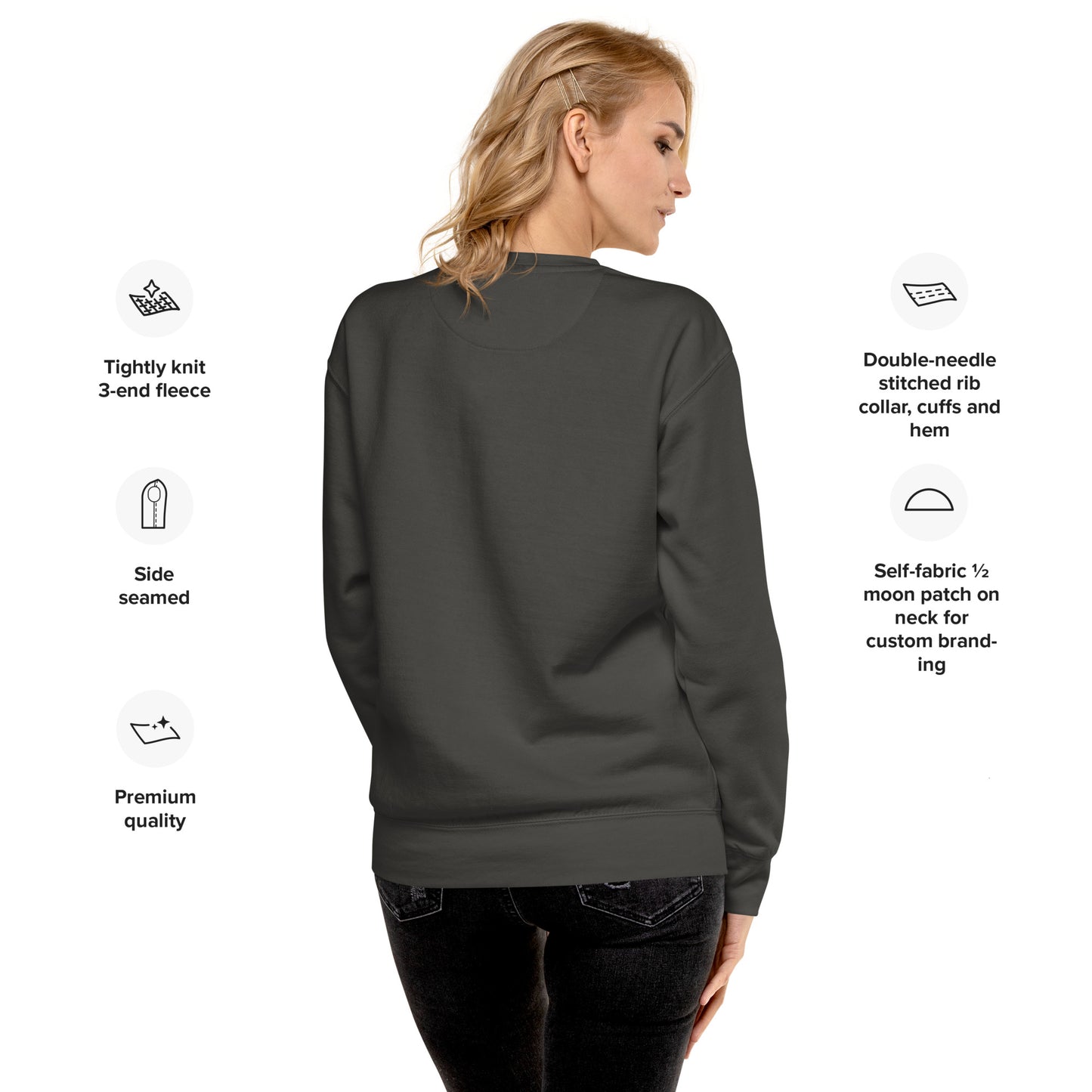 Woman wearing a dark gray sweatshirt with text detailing features on a white background